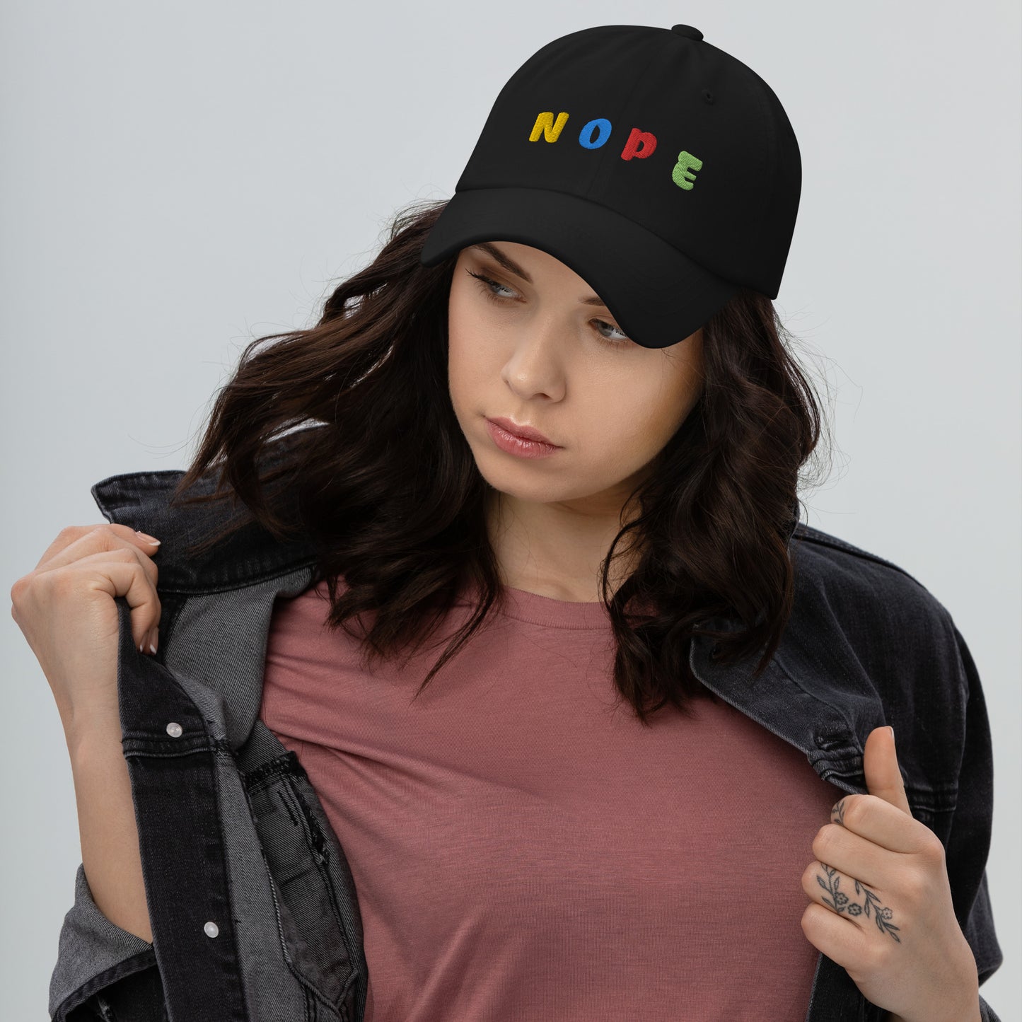 lady wearing black hat with "NOPE" written on front