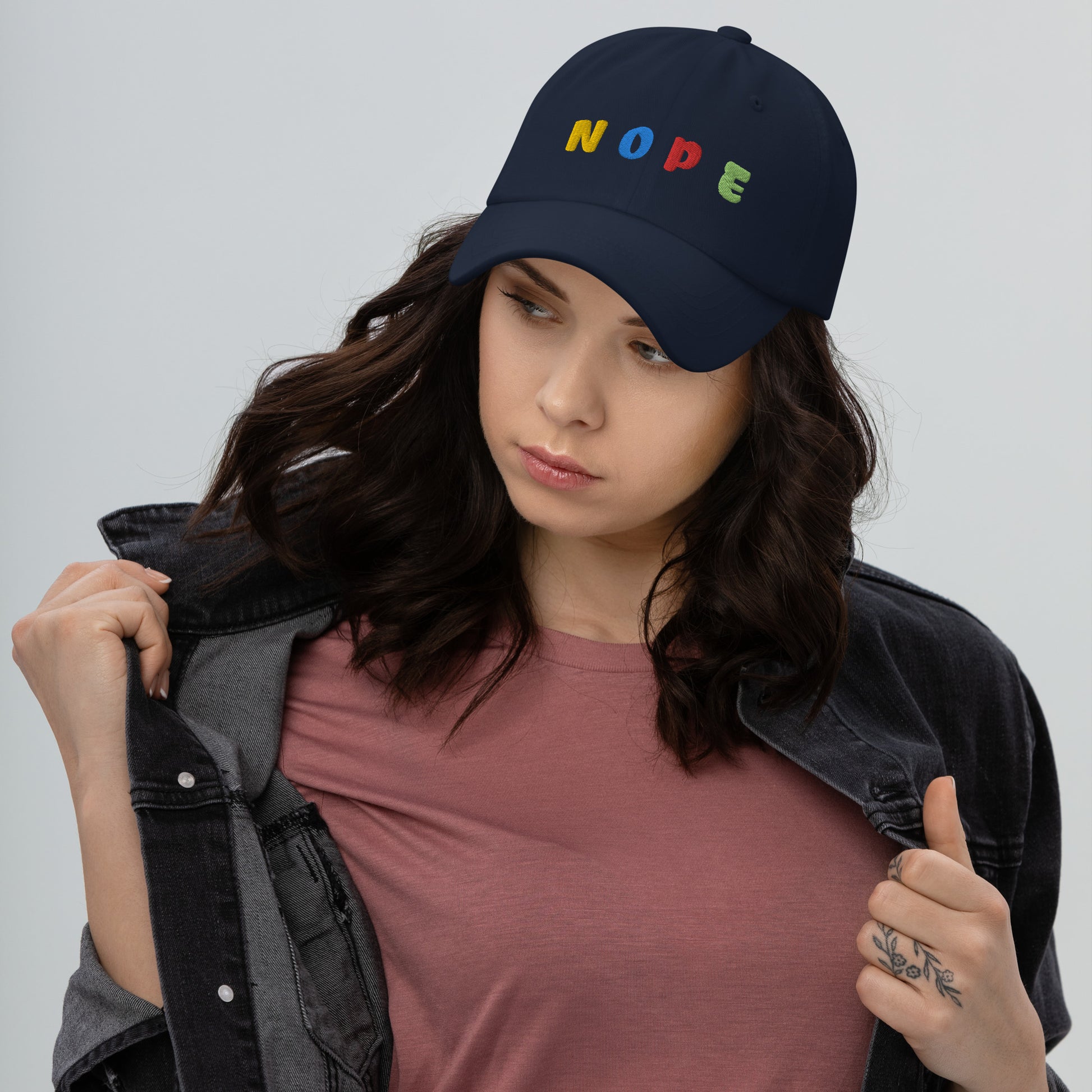 lady wearing navy color hat with "NOPE" written on front