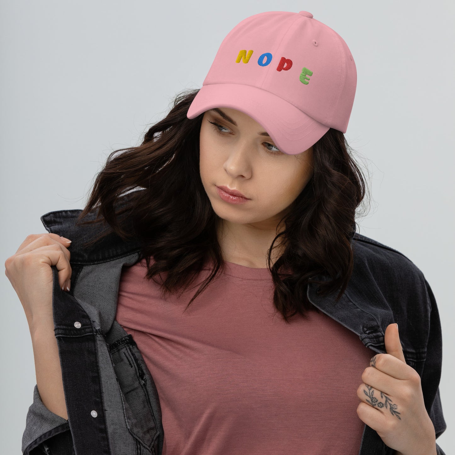 lady wearing pink hat with "NOPE" written on front