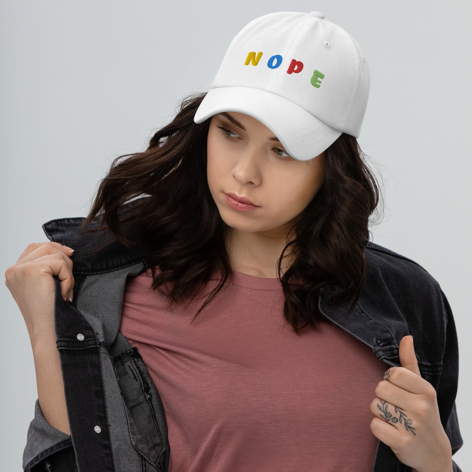 lady wearing white hat with "NOPE" written on front