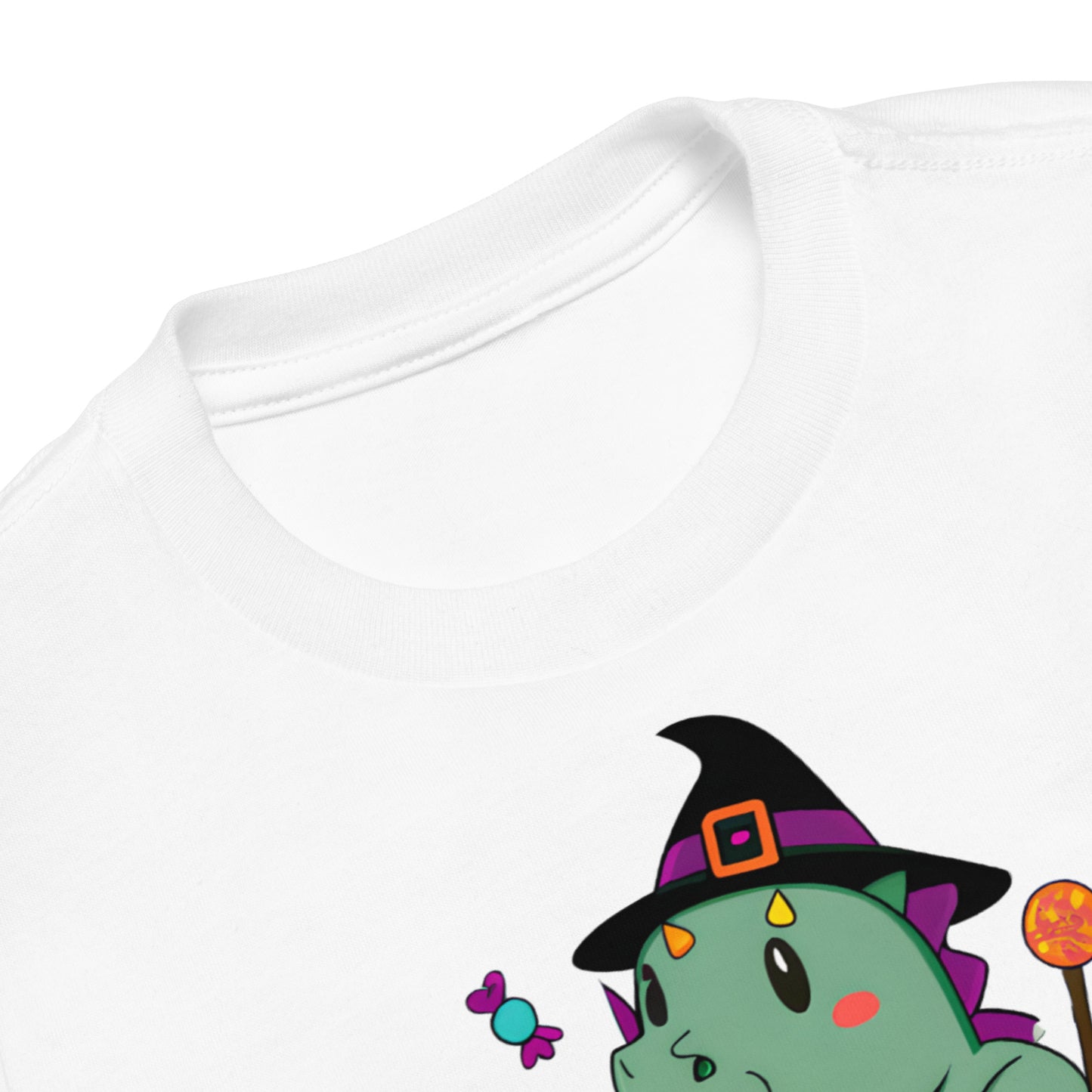 closeup of halloween t-shirt showing witch hat on dinosaur