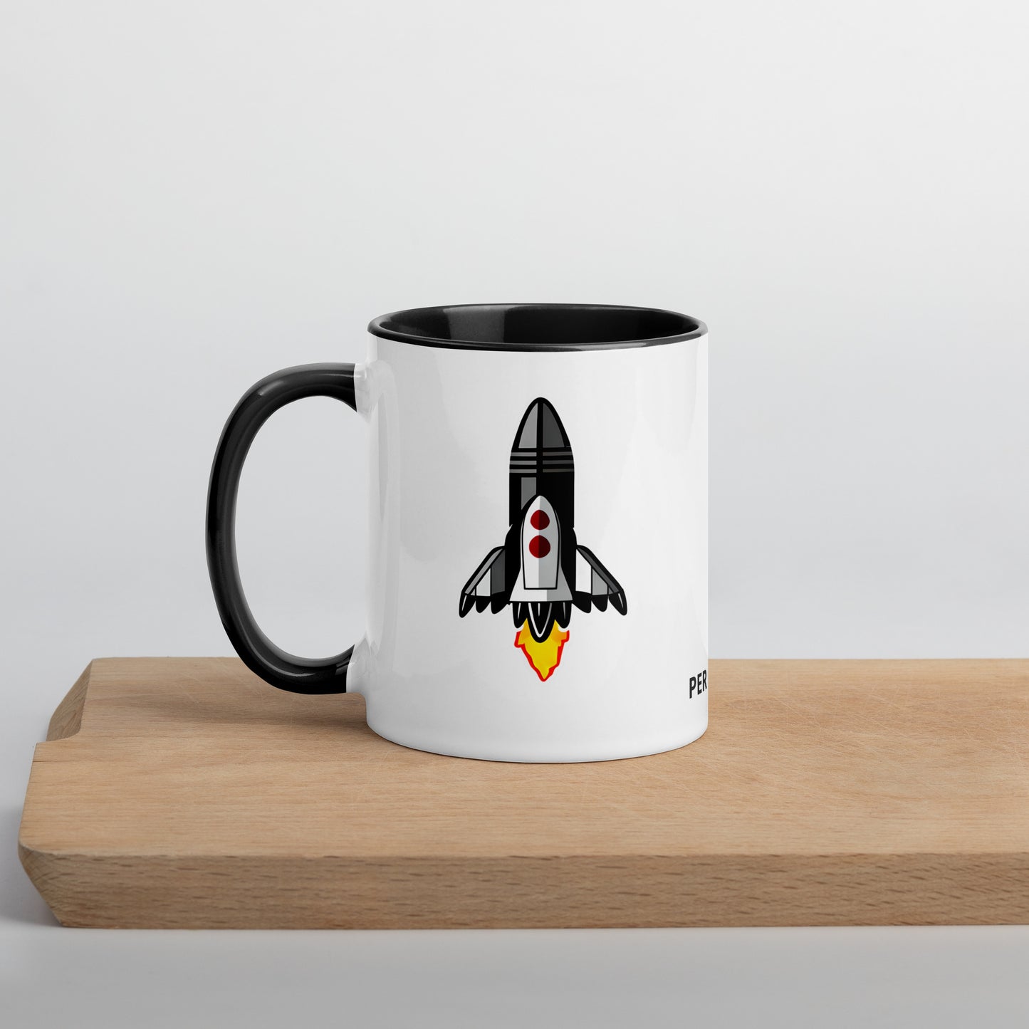side view of coffee mug showing rocketship