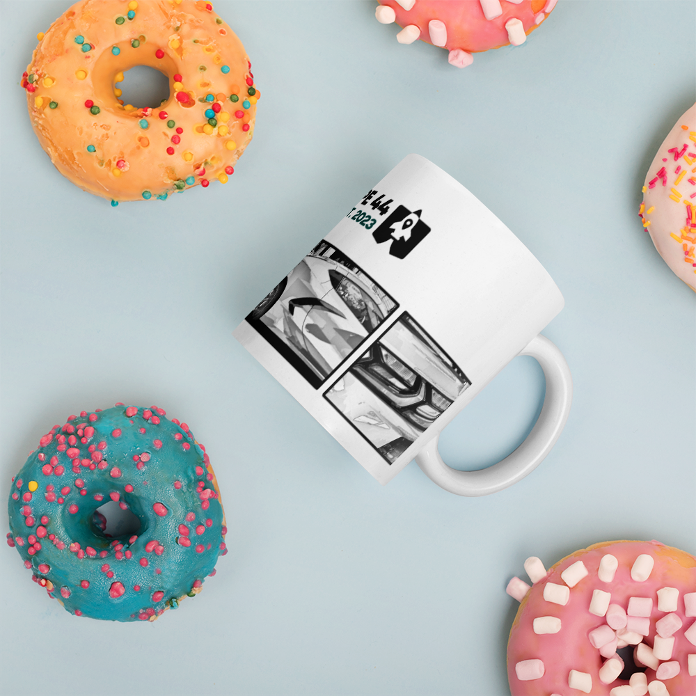 coffee mug on its side next to a few donuts
